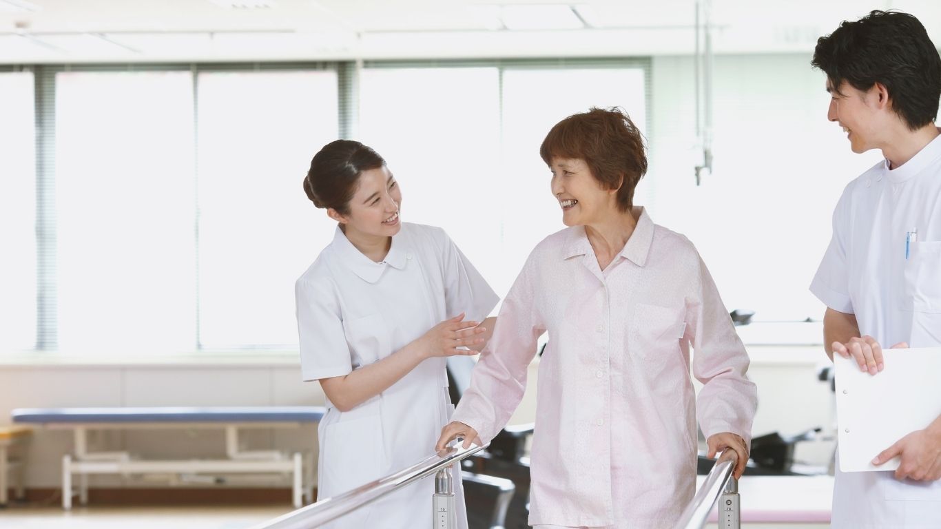 Nursing and healthcare professionals speaking with a patient